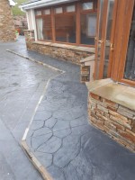 Gradiated layers around house in  pattern imprinted concrete by GM Hard Landscapes, County Donegal, Ireland
